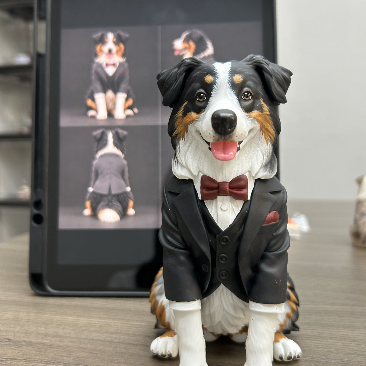 Custom 3D figurine of an Australian Shepherd in a tuxedo next to the reference photos it was made from