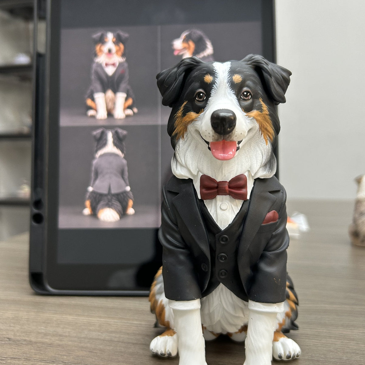 Custom Australian Shepherd figurine in a tuxedo and bow tie, shown next to the reference photos it was sculpted from
