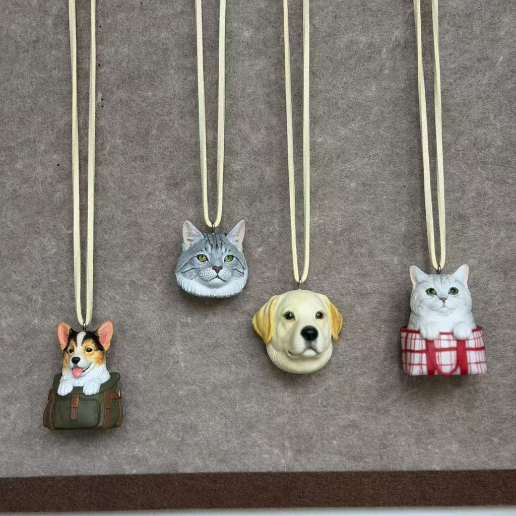 Custom pet charms of a corgi, tabby cat, labrador and silver cat hanging on cords